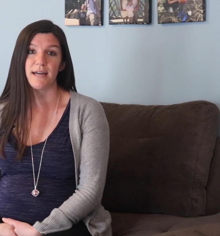 Amanda of Hanson, Massachusetts sits on her couch while discussing her experience at South Shore Hospital's Obstetrics Emergency Department