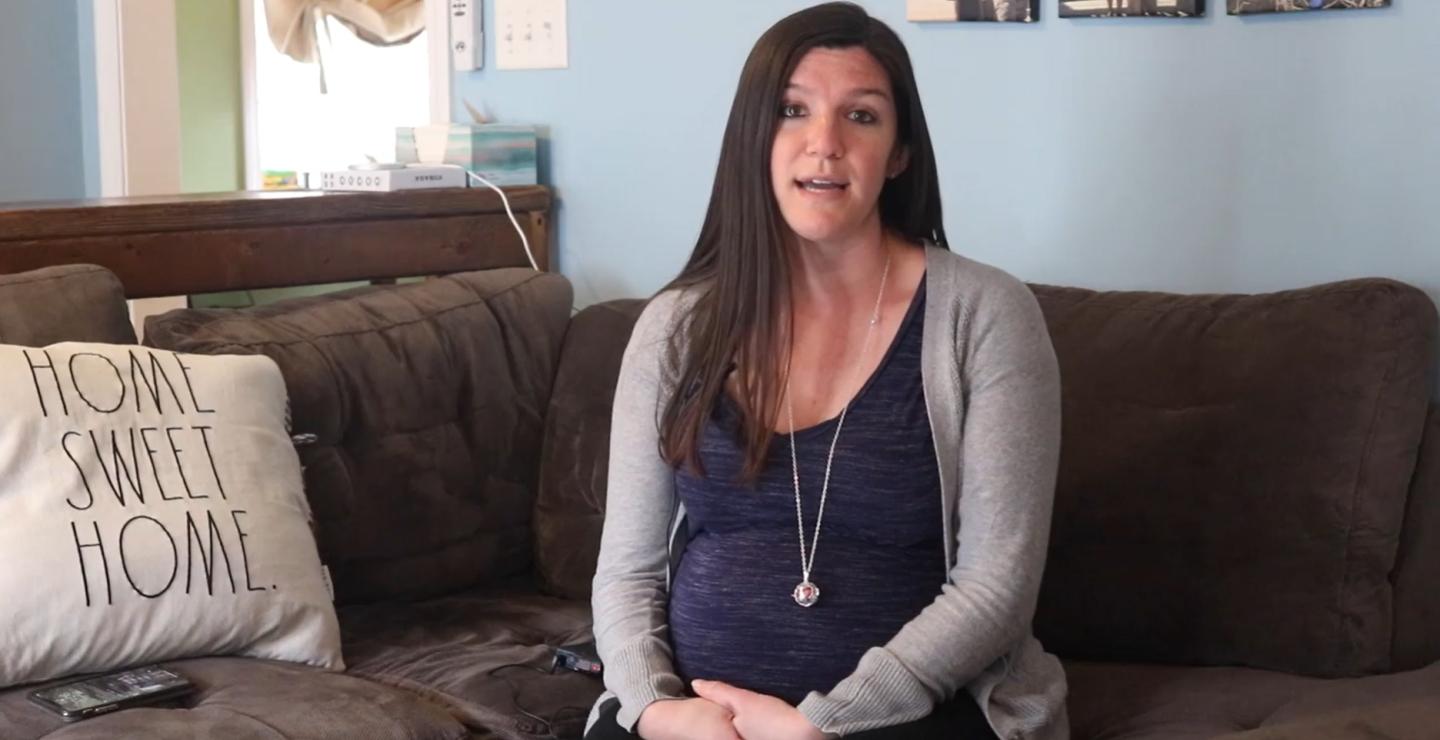 Amanda of Hanson, Massachusetts sits on her couch while discussing her experience at South Shore Hospital's Obstetrics Emergency Department