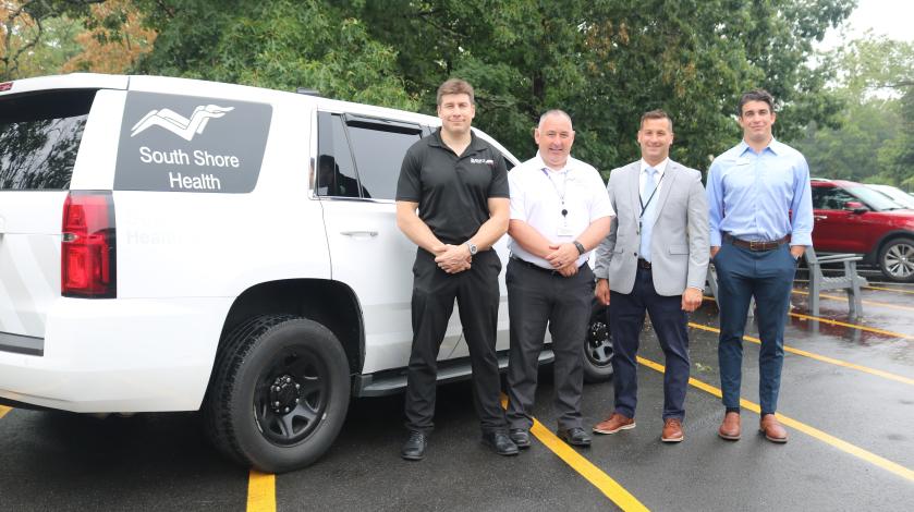 Ben Shulman, Dealer Principal, Best Automotive; Eugene Duffy, Director of South Shore EMS; William Tollefsen, MD, Vice Chair of Emergency Medicine and Urgent Care, South Shore Health; and Alex Shulman, Dealer Principal, Best Automotive stand alongside an emergency response vehicle donated by Best Automotive to South Shore EMS.