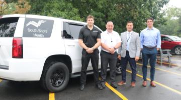 Ben Shulman, Dealer Principal, Best Automotive; Eugene Duffy, Director of South Shore EMS; William Tollefsen, MD, Vice Chair of Emergency Medicine and Urgent Care, South Shore Health; and Alex Shulman, Dealer Principal, Best Automotive stand alongside an emergency response vehicle donated by Best Automotive to South Shore EMS.