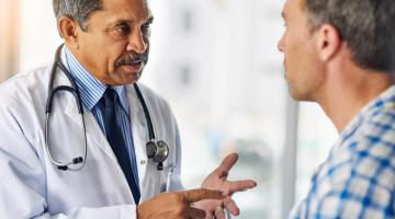 Doctor consulting with a middle aged male patient