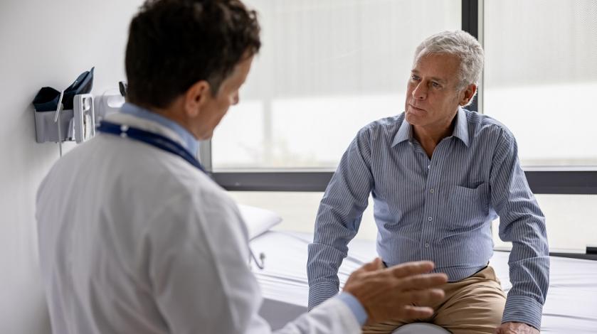 A doctor consults with a older male patient