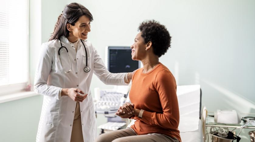 A female practitioner consults with middle aged female patient