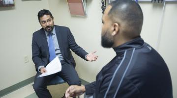 A surgeon consulting with an African-American man