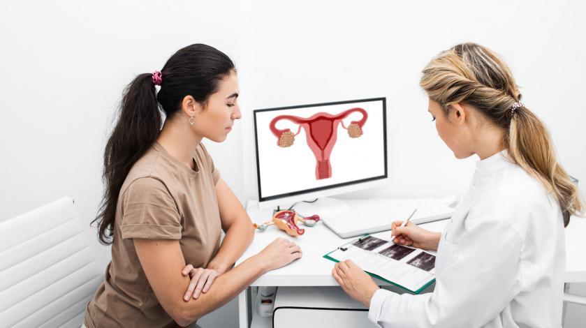 A gynecologist speaks with a young female patient