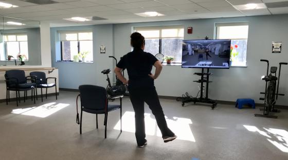 An instructor leads a virtual exercise class