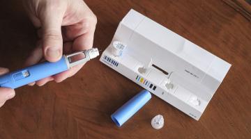 A man holds an injectable weight loss drug