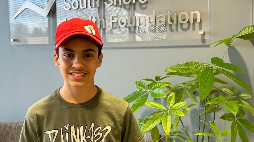 Teen age boy wearing American Heart Association baseball cap
