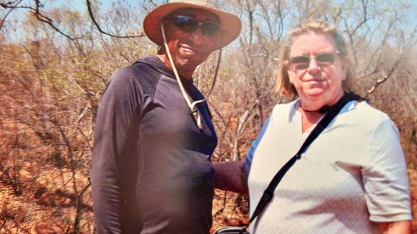 A man and woman pose for a photo in an animal preserve in South Africa