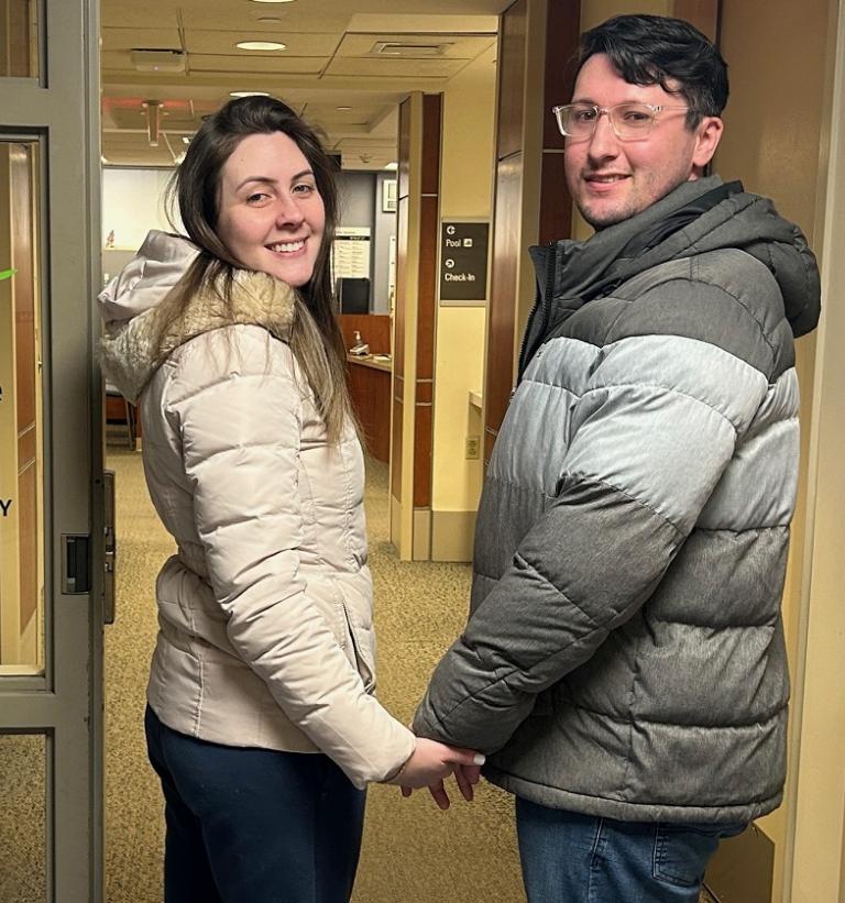 A woman and a man hold hands as they enter South Shore Health Physical Therapy and Wellness