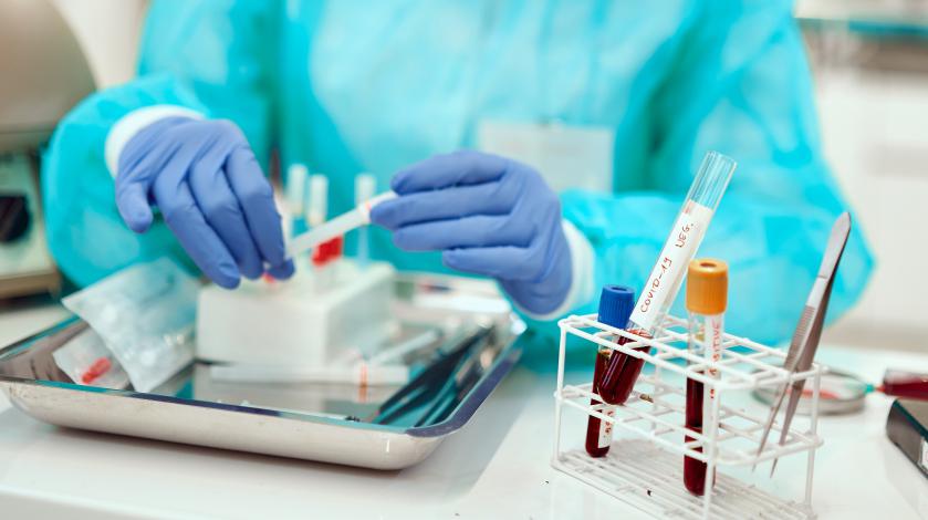 Close-up view of a laboratory worker working with vials of blood doing general lab work