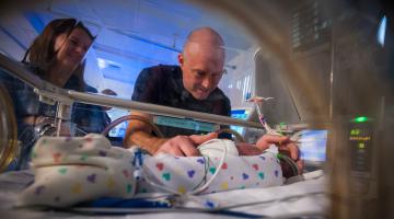Mom and dad holding premature son