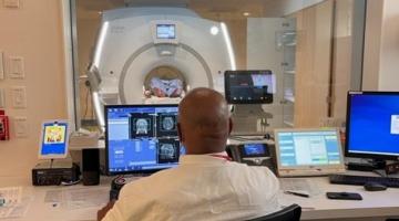 An MRI technologist reviewing scans