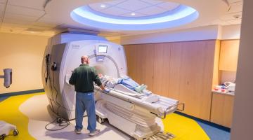 MRI tech getting patient ready for MRI sccan
