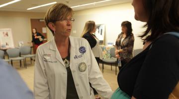 Nannette Landry, Certified Nurse Midwife, talks to a mom