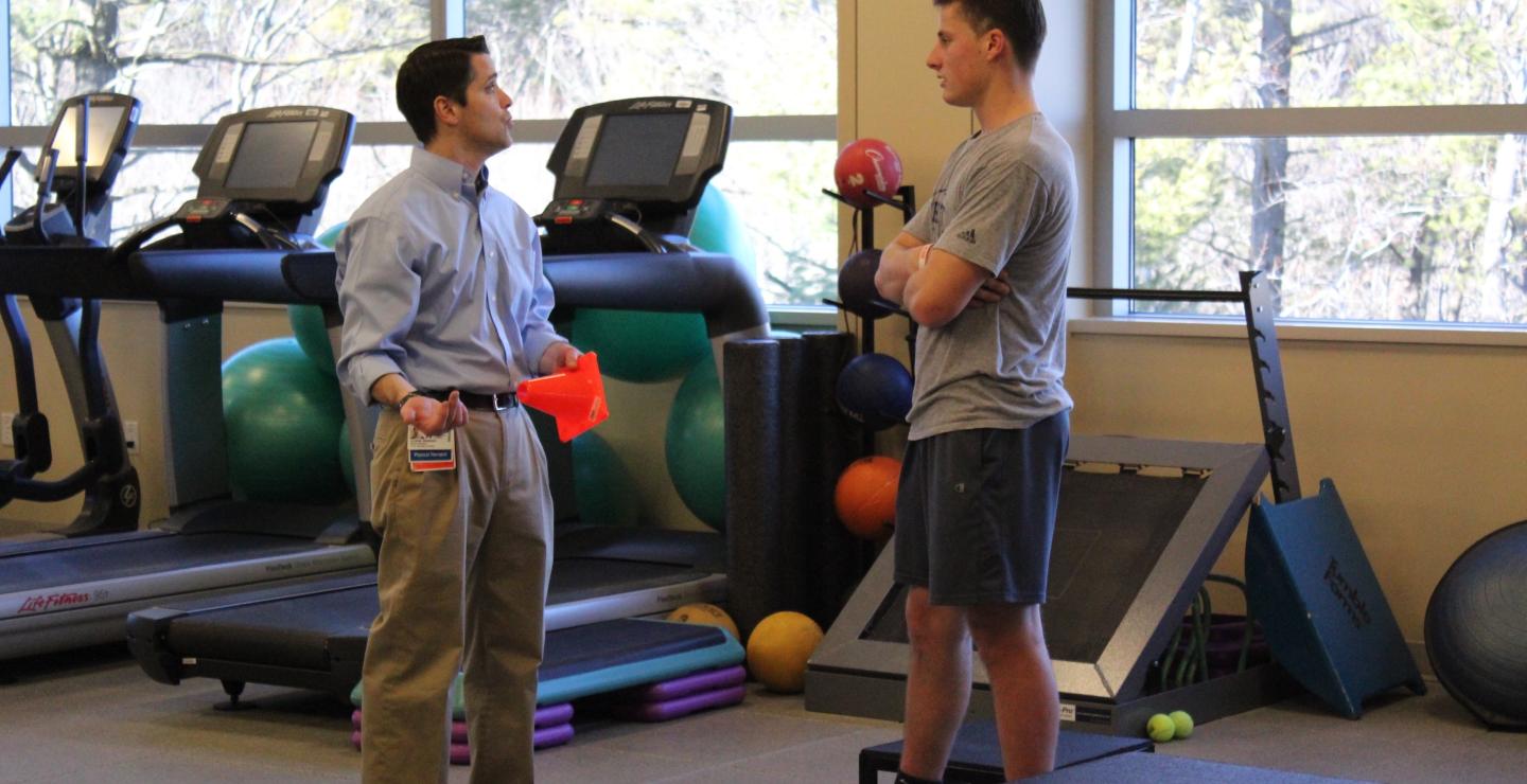 Patient Nick Hall takes a break from therapy to talk with PT Dan Murray at South Shore Health