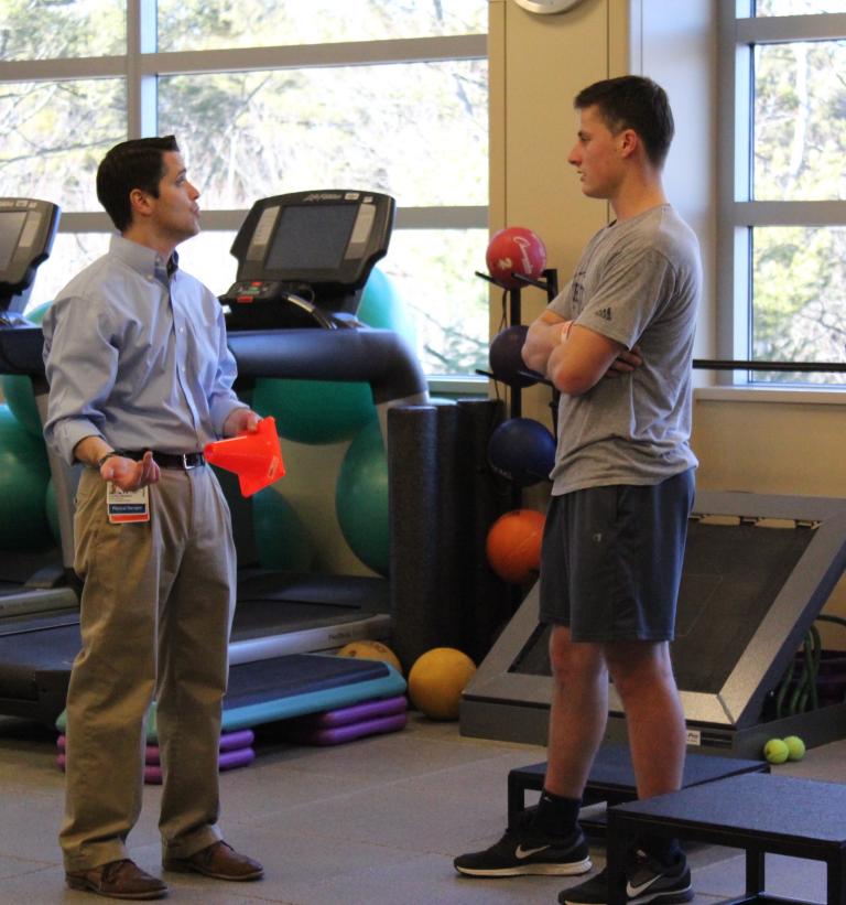 Patient Nick Hall takes a break from therapy to talk with PT Dan Murray at South Shore Health