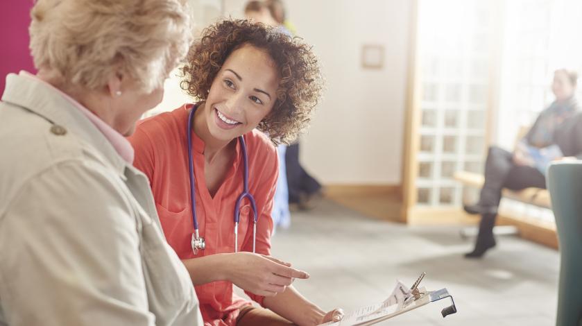 A female nurse gets medical history from an older woman