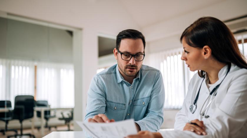 A nurse reviews a patient's information