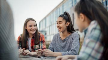 Young adults chat outside of school