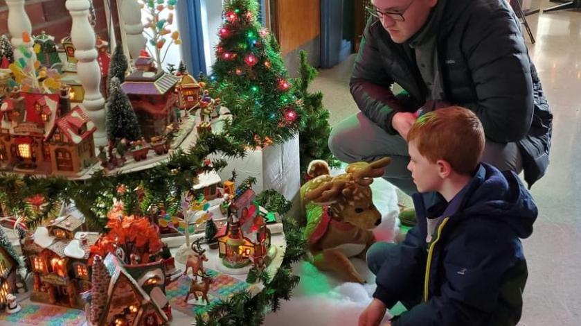 Father and son checking out a holiday village display
