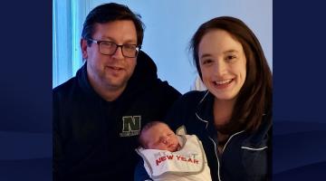 Justin and Renai Townsend hold their New Year's baby, which was born in the backseat of their car.
