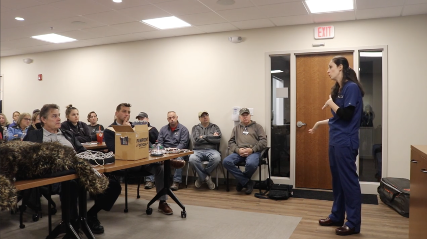 A veterinarian from Weymouth VCA stands in front of a classroom teaching first responders basic K9 first aid