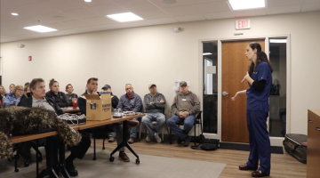 A veterinarian from Weymouth VCA stands in front of a classroom teaching first responders basic K9 first aid